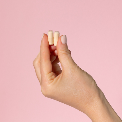 Two pullulan capsules held between finger and thumb